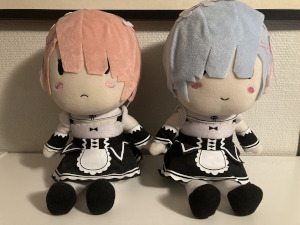 Two plushies, one of Ram and one of Rem, two characters from the Re:Zero anime.